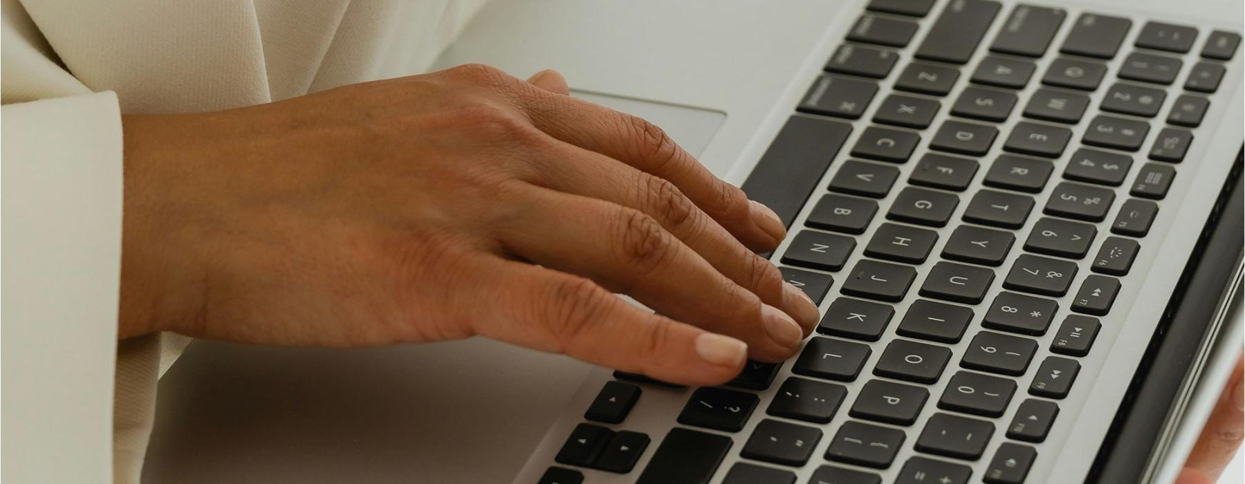 a person typing on a laptop