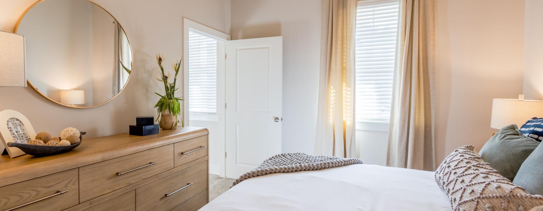 a bedroom with a bed and a mirror