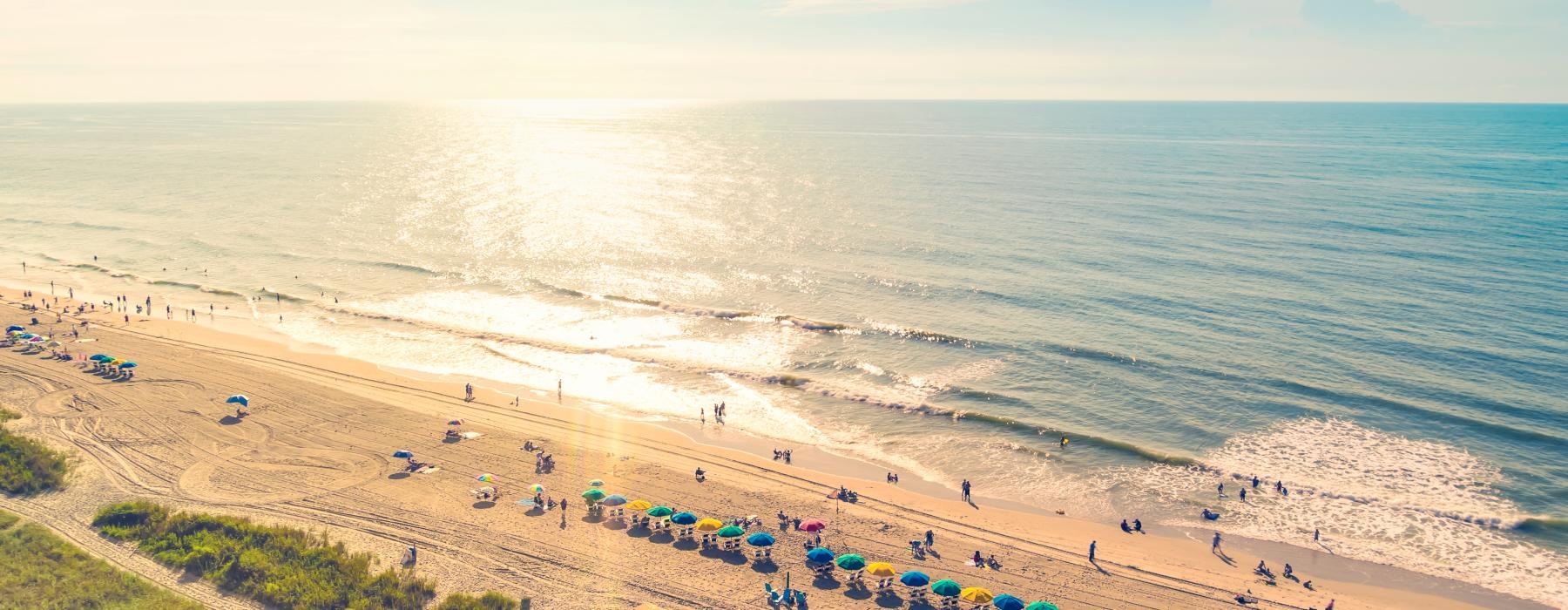a beach with many people on it