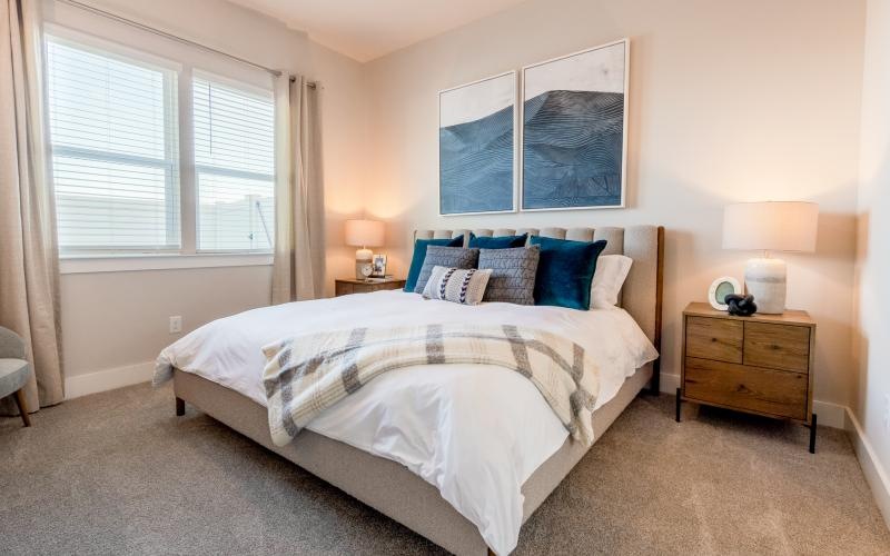 a bed with blue and white pillows